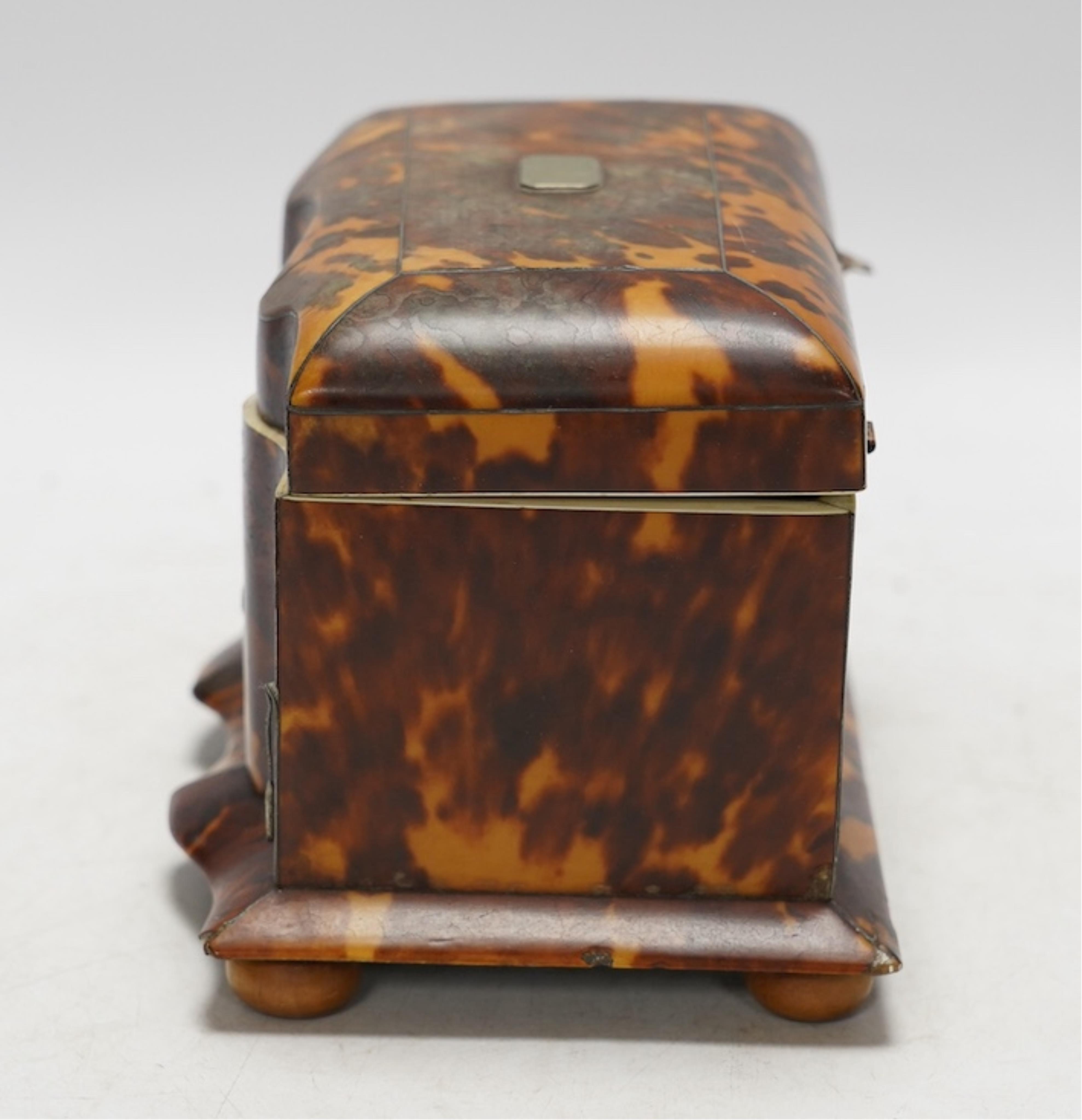 A Regency tortoiseshell tea caddy with inlaid silver and ivory stringing, on later bun feet, 12cm high. CITES Submission reference 64HKMP8J. Condition - poor to fair, lid detached, some repairs needed to stringing